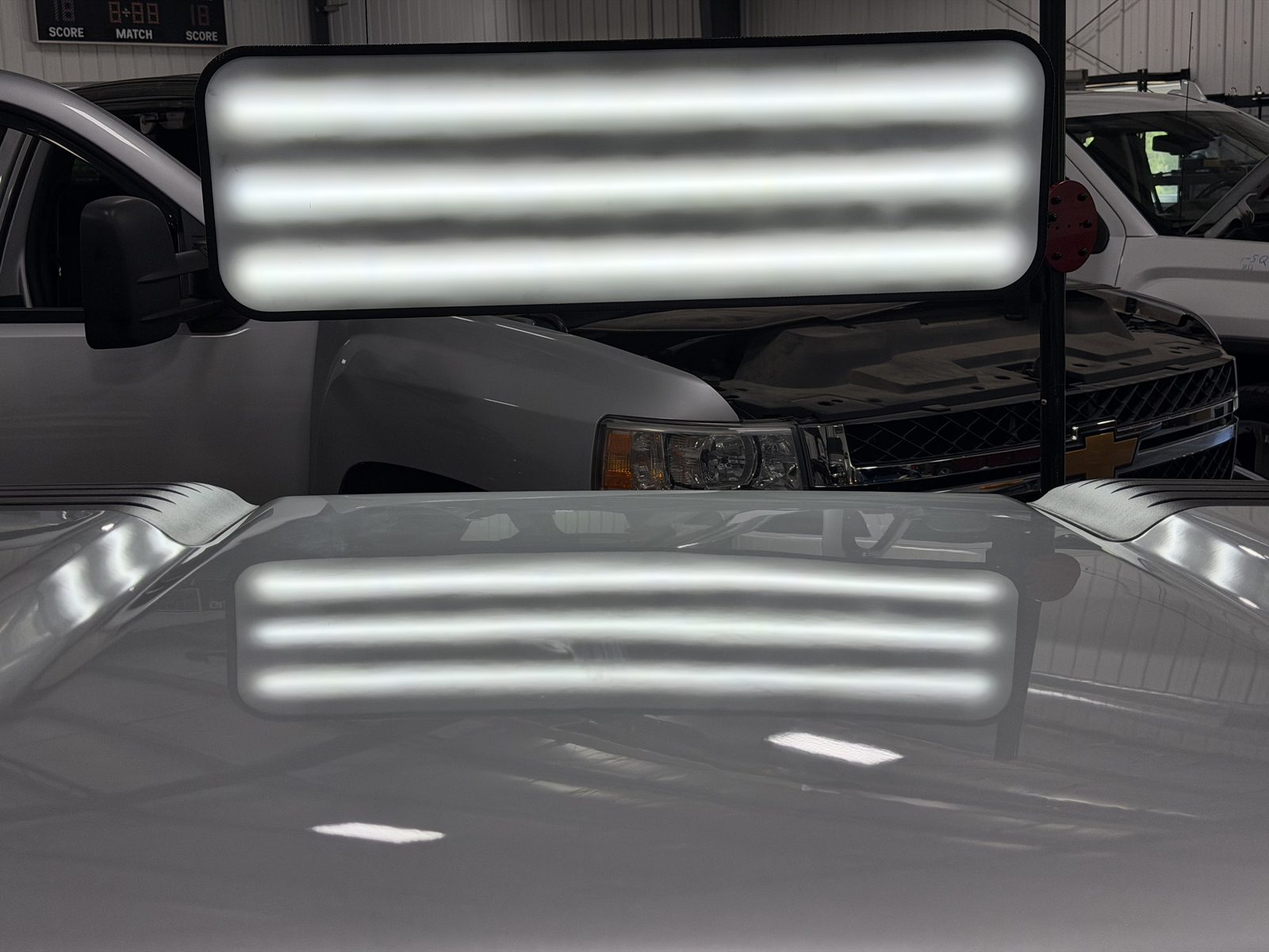 Same hood after paintless dent repair, reflection lines straight and dents removed